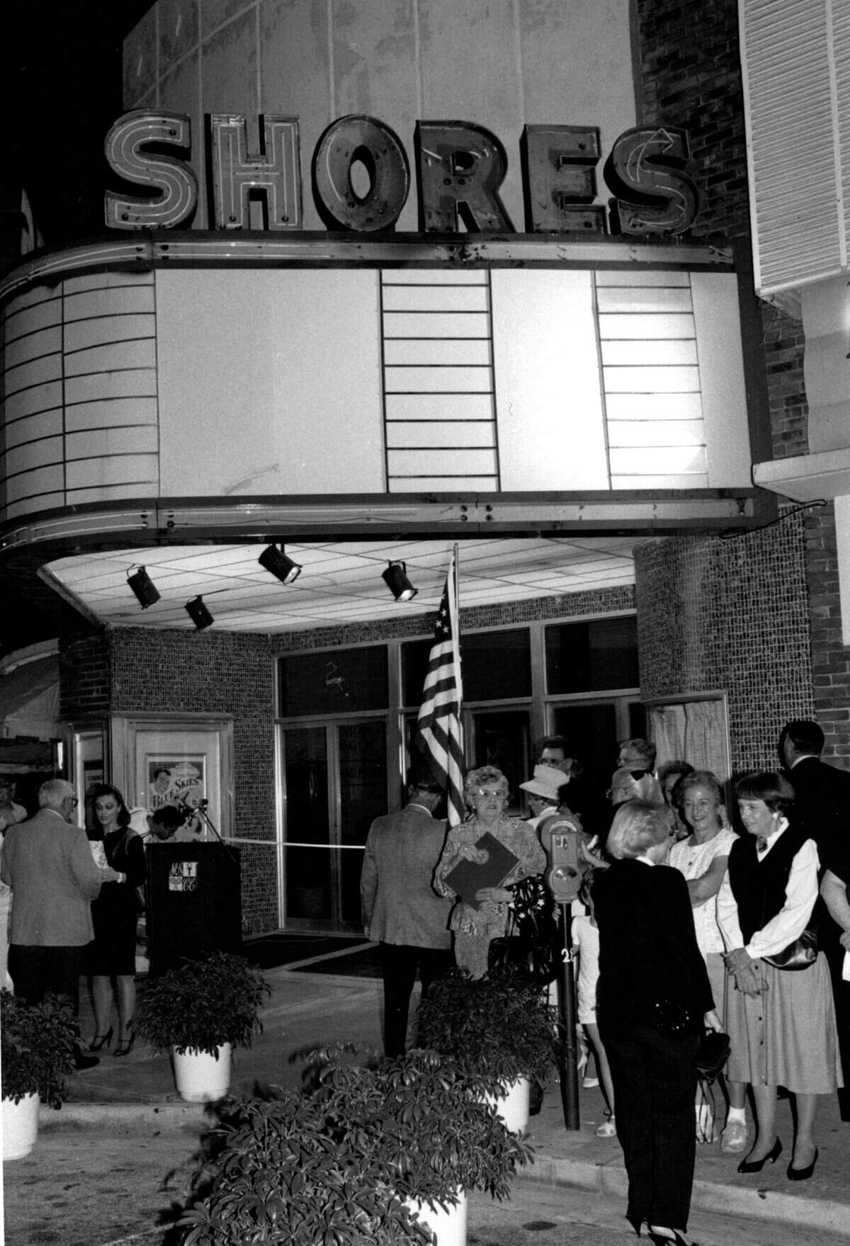 People mingle outside the grand opening of the Shores Theater.